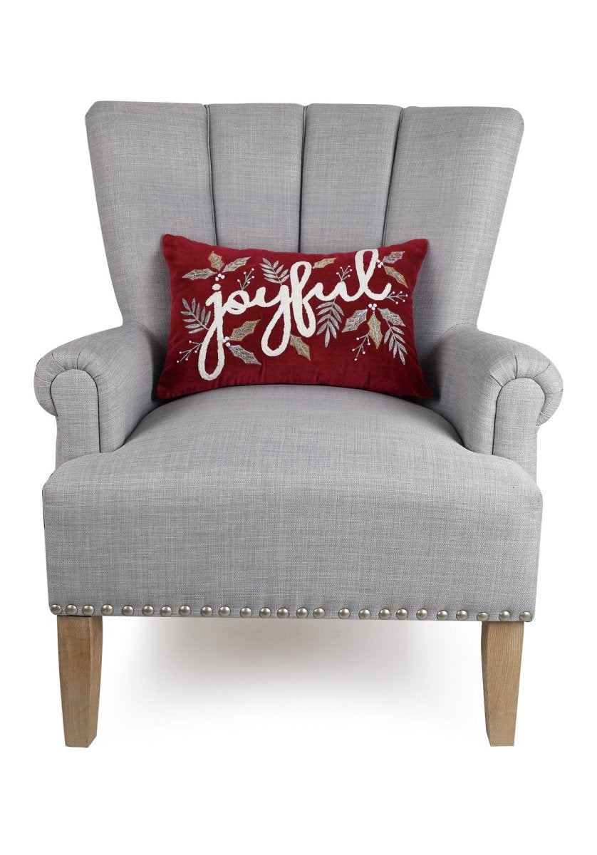 Gilded Joyful Embroidered Christmas Throw Pillow on an armchair, showing the throw pillow at room scale, 12x18 inch