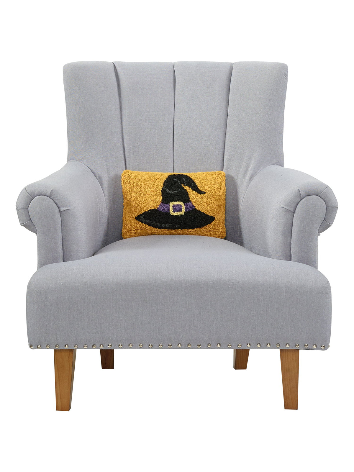 Gold Ground Witch Hat Hooked Wool Halloween Throw Pillow on an armchair, showing the throw pillow at room scale, 8x12 inch