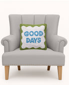 Good Days Hooked Wool Throw Pillow on an armchair, showing the throw pillow at room scale, 14x14 inch