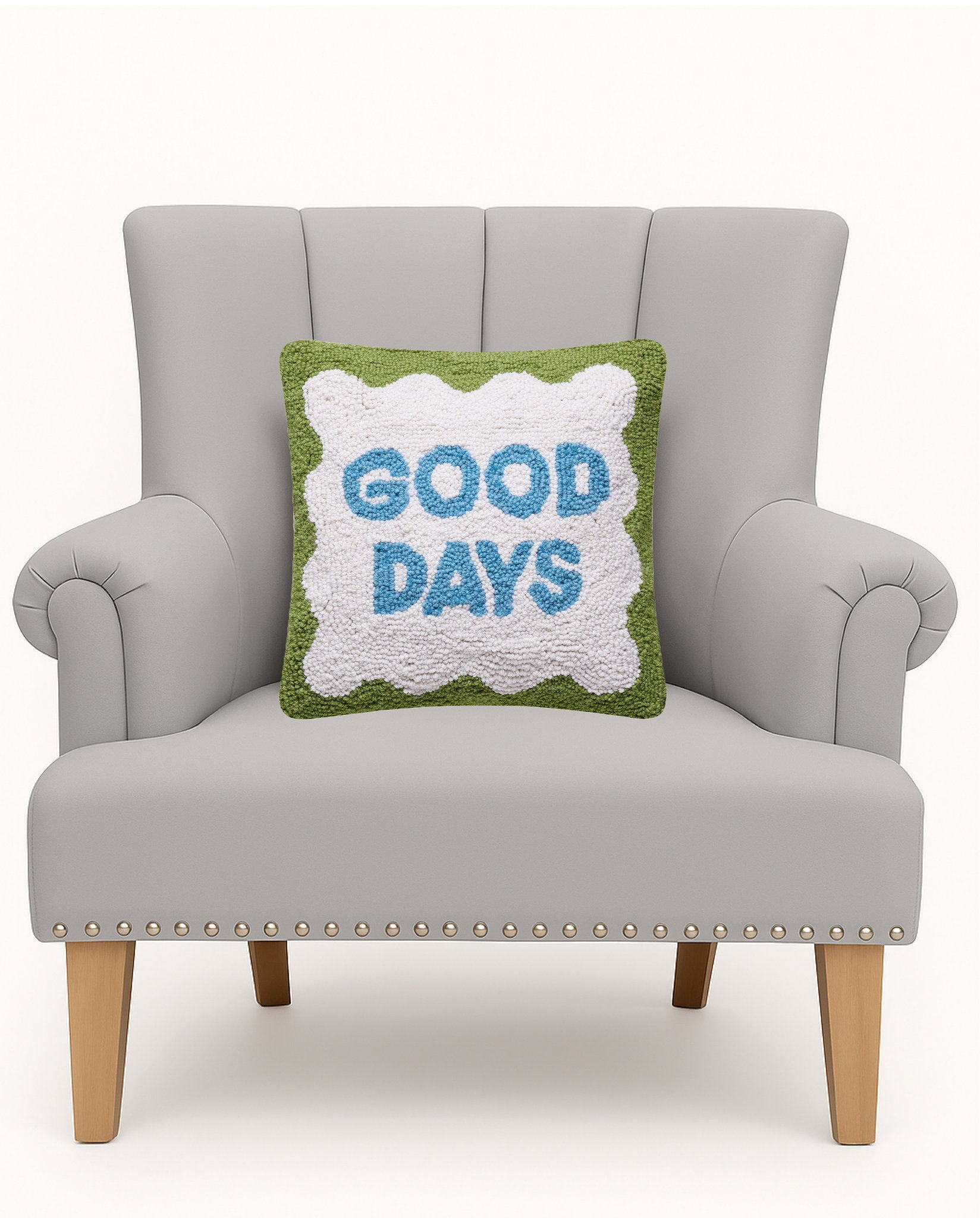 Good Days Hooked Wool Throw Pillow on an armchair, showing the throw pillow at room scale, 14x14 inch