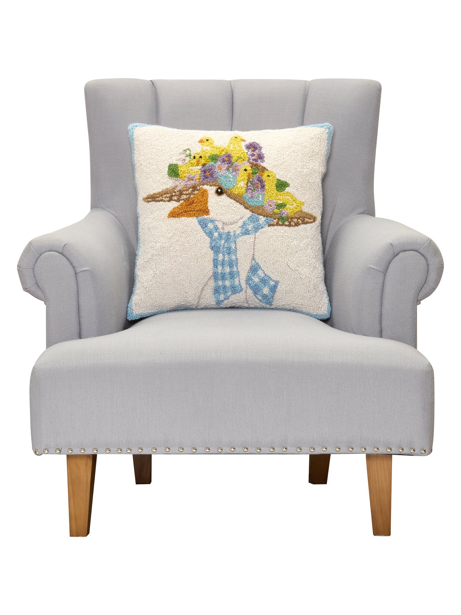 Goose Hooked Wool Throw Pillow on an armchair, showing the throw pillow at room scale, 18x18 inch