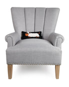Halloween Dachshund Hooked Wool Throw Pillow on an armchair, showing the throw pillow at room scale, 12x5 inch