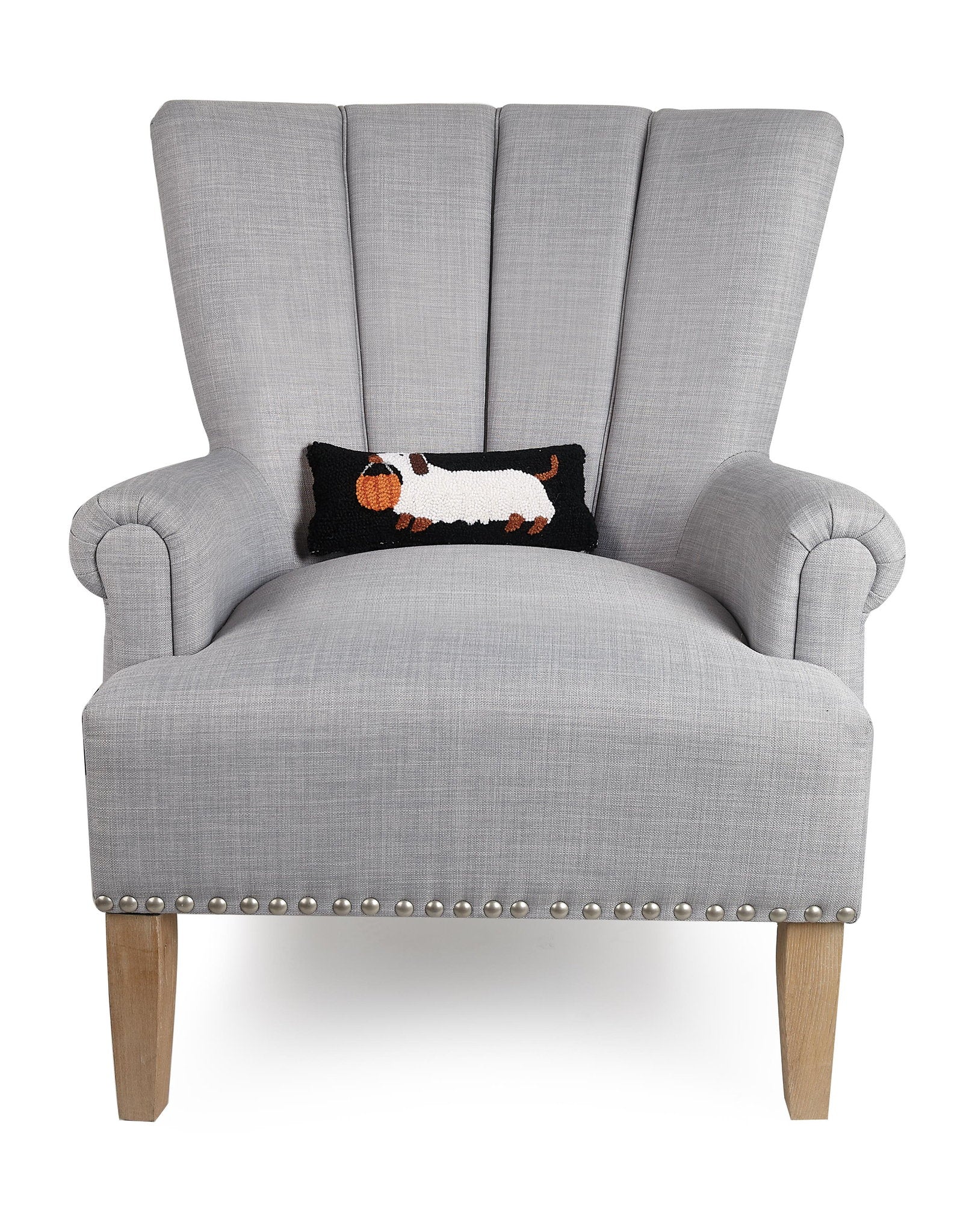 Halloween Dachshund Hooked Wool Throw Pillow on an armchair, showing the throw pillow at room scale, 12x5 inch