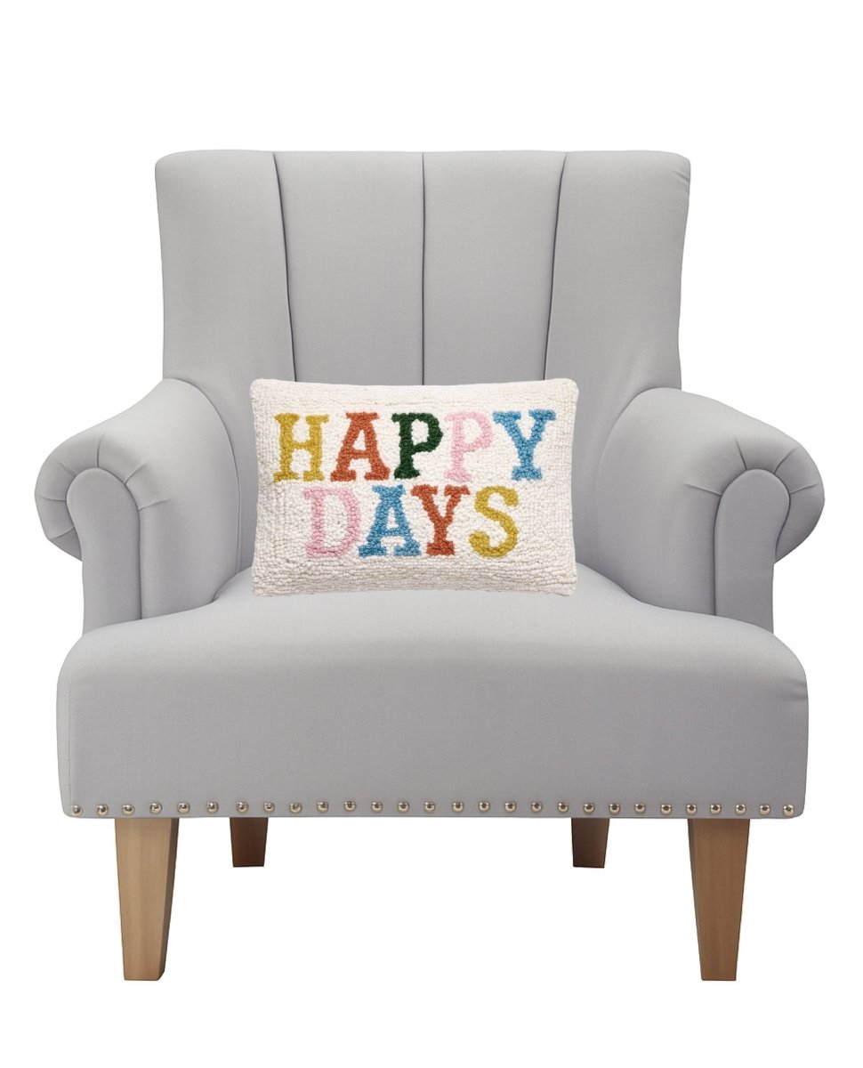 Happy Days Hooked Wool Throw Pillow on an armchair, showing the throw pillow at room scale, 8x12 inch