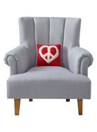 Heart Anchor Hooked Wool Throw Pillow on an armchair, showing the throw pillow at room scale, 10x10 inch