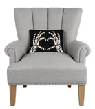 Heart Skeleton Hand Hooked Wool Halloween Throw Pillow on an armchair, showing the throw pillow at room scale, 8x12 inch