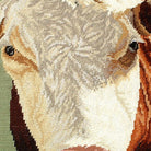 Closeup of Hereford Cow Farm Animal needlepoint throw pillow highlighting hand-stitched wool craftsmanship and fabric detail