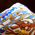 Hill Country Bluebonnets Embroidered Travel Pillow - close-up detail of hand-embroidered needlepoint stitching