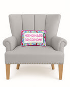 Hoho Hard Go Home Embroidered Needlepoint Christmas Throw Pillow on an armchair, showing the throw pillow at room scale, 8x12 inch