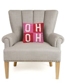 Hoho Hooked Wool Christmas Throw Pillow on an armchair, showing the throw pillow at room scale, 10x10 inch