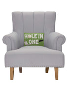 Hole in One Hooked Wool Throw Pillow on an armchair, showing the throw pillow at room scale, 8x12 inch