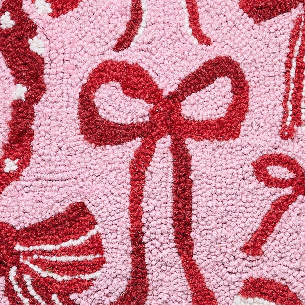 Closeup of Holiday Bows Hooked Wool Christmas Throw Pillow showing stitch texture and craftsmanship detail