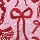 Closeup of Holiday Bows Hooked Wool Christmas Throw Pillow showing stitch texture and craftsmanship detail