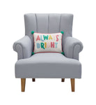 Holiday Bright's Always with Pom Poms Embroidered Throw Pillow, 12x16 inch, lettered lumbar pillow on a gray armchair