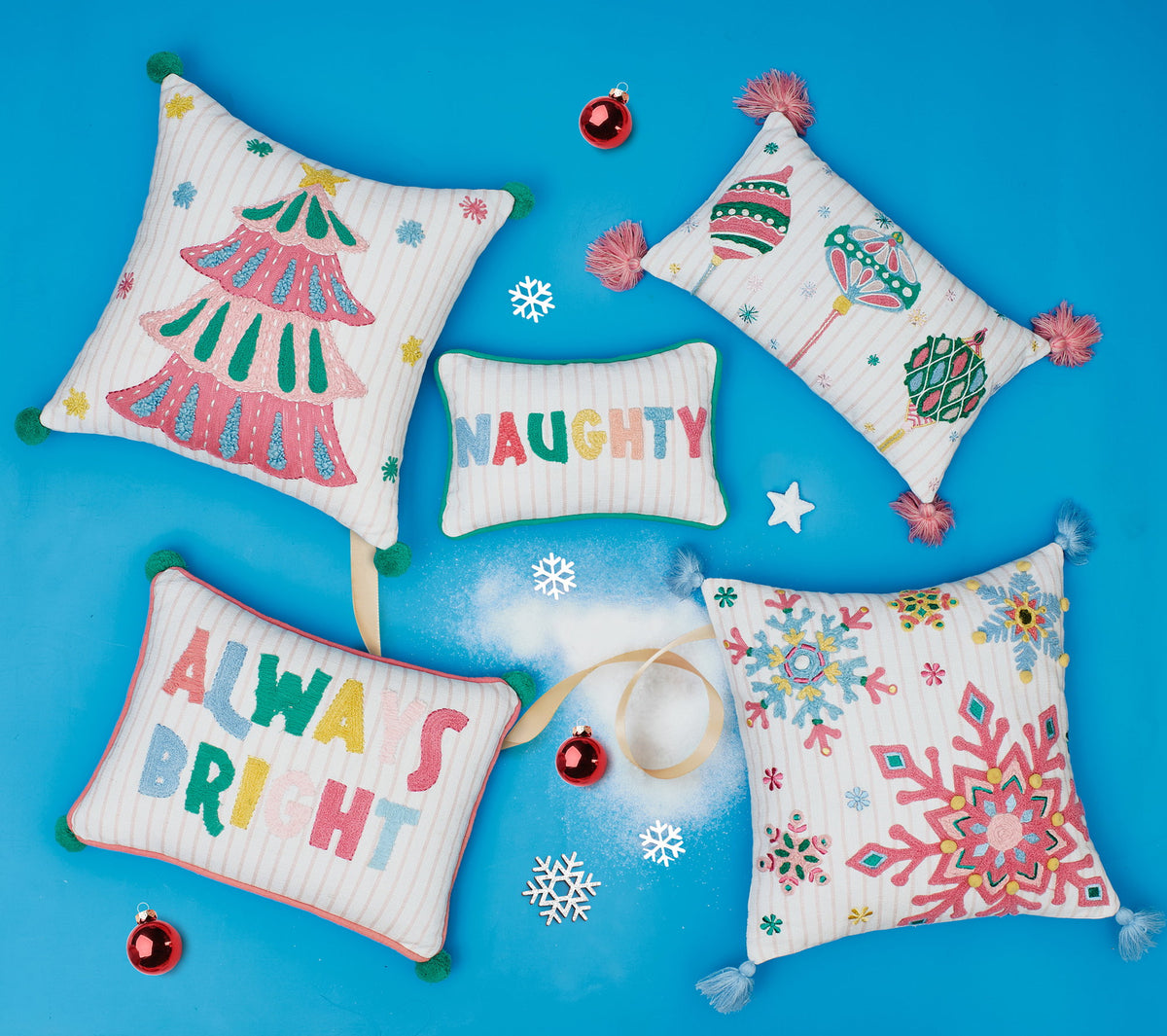 Holiday Bright's Always with Pom Poms Embroidered Throw Pillow, 12x16 inch, five pillows in the group on a blue backdrop