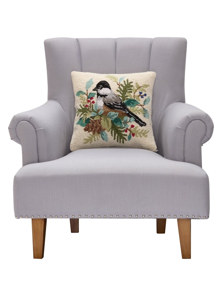 Holiday Chickadee Hooked Wool Throw Pillow on an armchair, showing the throw pillow at room scale, 16x16 inch