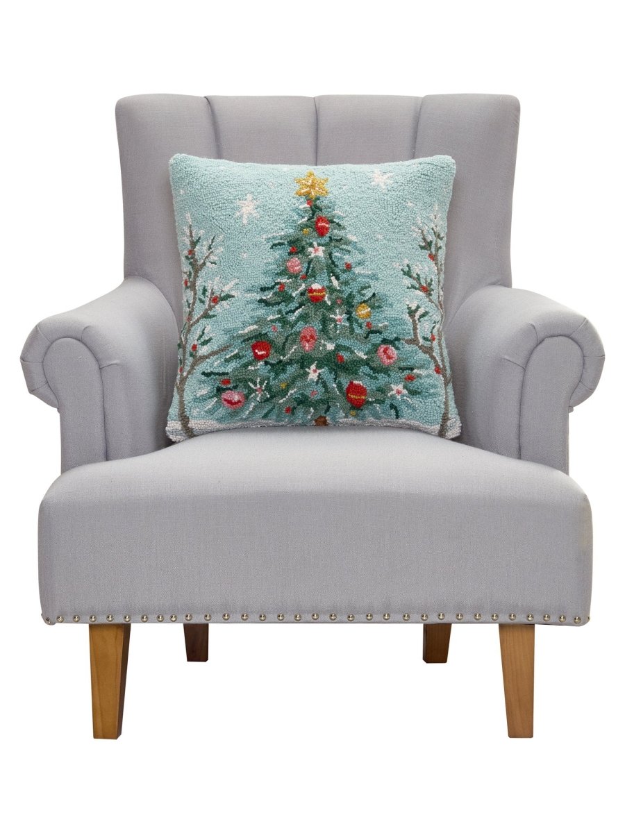 Holiday Christmas Tree Hooked Wool Throw Pillow on an armchair, showing the throw pillow at room scale, 18x18 inch