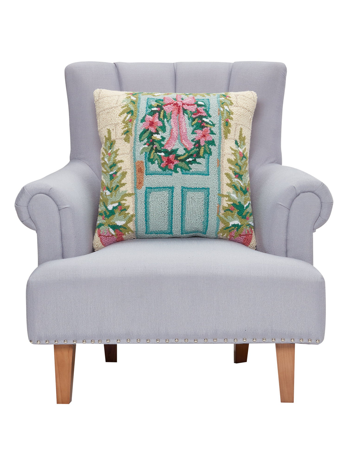Holiday Front Porch Hooked Wool Christmas Throw Pillow on an armchair, showing the throw pillow at room scale, 20x20 inch