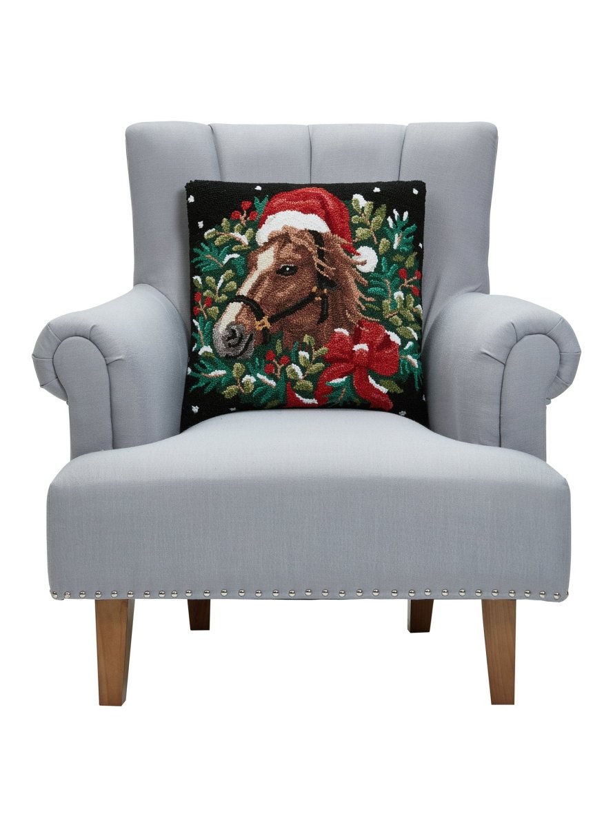 Holiday Horse Hooked Wool Christmas Throw Pillow on an armchair, showing the throw pillow at room scale, 18x18 inch