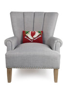 Holiday Ice Skates Hooked Wool Christmas Throw Pillow on an armchair, showing the throw pillow at room scale, 8x12 inch