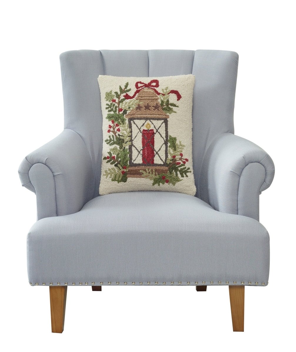 Holiday Lantern Hooked Wool Christmas Throw Pillow on an armchair, showing the throw pillow at room scale, 14x18 inch