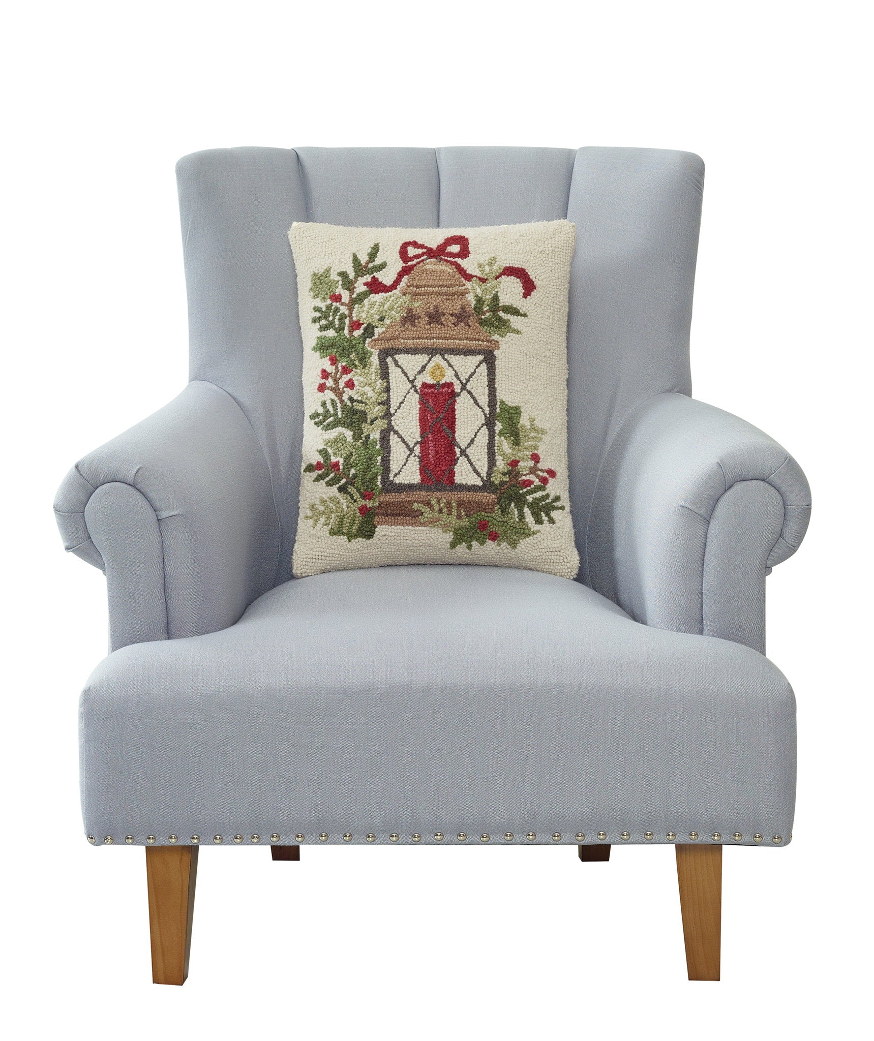 Holiday Lantern Hooked Wool Christmas Throw Pillow on an armchair, showing the throw pillow at room scale, 14x18 inch