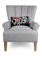 Holiday Mushrooms Cheer Hooked Wool Christmas Throw Pillow on an armchair, showing the throw pillow at room scale, 9x16 inch