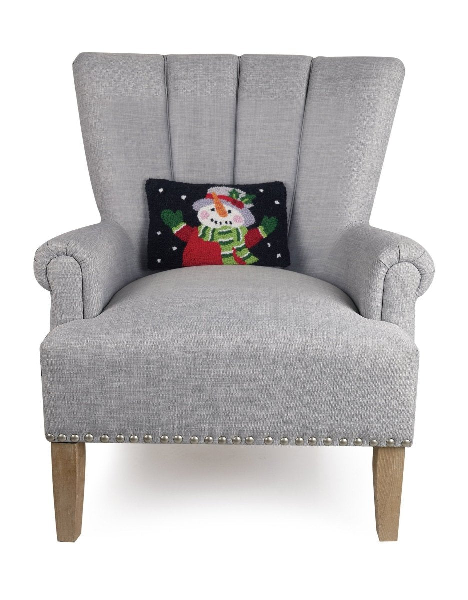 Holiday Snowman Hooked Wool Christmas Throw Pillow on an armchair, showing the throw pillow at room scale, 8x12 inch