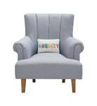Holiday Stripes Naughty/Nice Reversible Embroidered Throw Pillow, 8x12 inch, the naughty pillow on a gray armchair