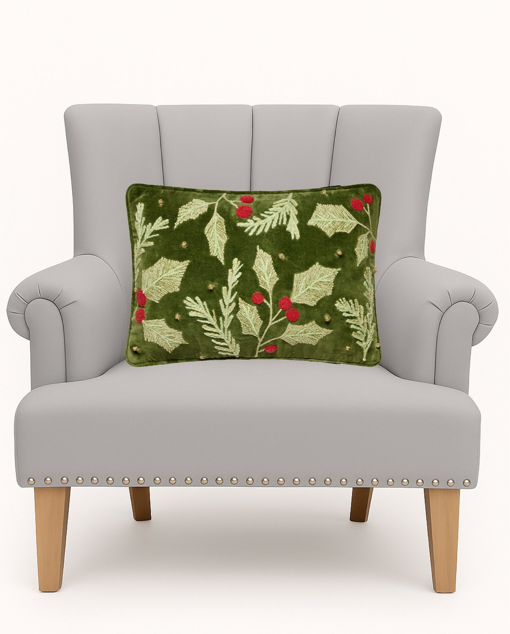 Holly Embroidered Christmas Throw Pillow on an armchair, showing the throw pillow at room scale, 12x18 inch