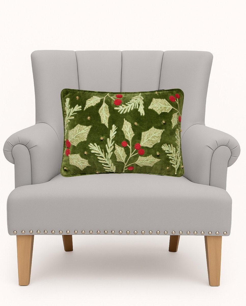 Holly Embroidered Christmas Throw Pillow on an armchair, showing the throw pillow at room scale, 12x18 inch