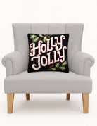 Holly Jolly Hooked Wool Christmas Throw Pillow on an armchair, showing the throw pillow at room scale, 16x16 inch