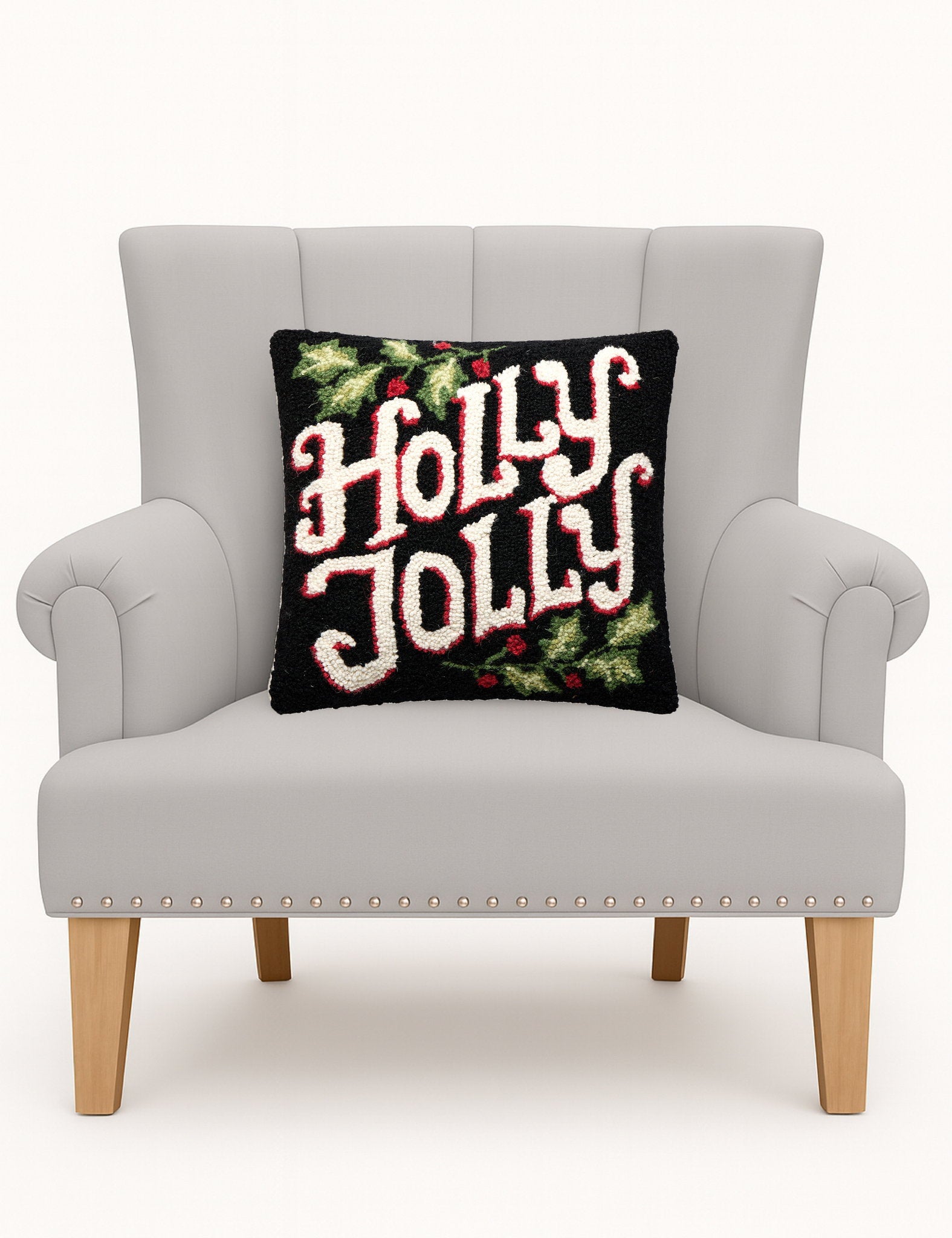 Holly Jolly Hooked Wool Christmas Throw Pillow on an armchair, showing the throw pillow at room scale, 16x16 inch