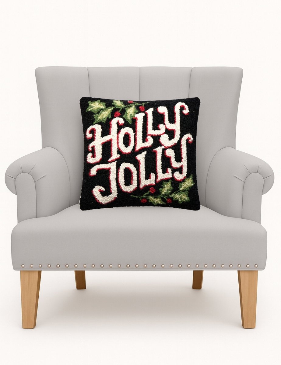 Holly Jolly Hooked Wool Christmas Throw Pillow on an armchair, showing the throw pillow at room scale, 16x16 inch