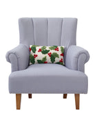 Holly with Berries Hooked Christmas Throw Pillow on an armchair, showing the throw pillow at room scale, 9x16 inch