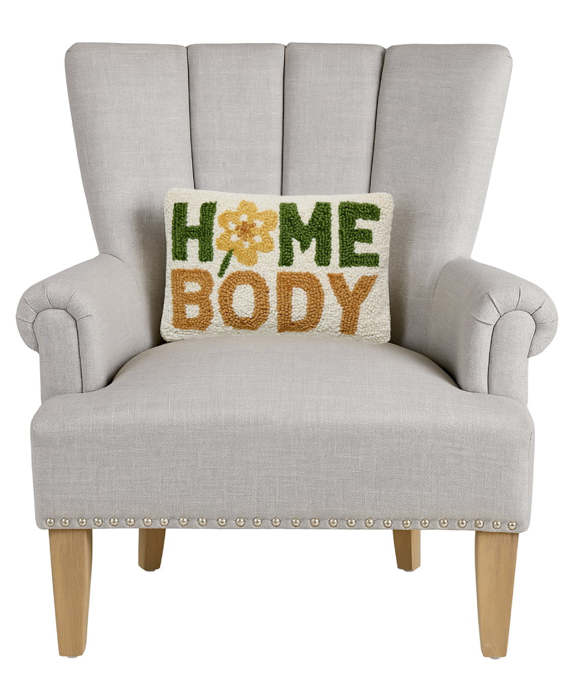Home Body Hooked Wool Throw Pillow on an armchair, showing the throw pillow at room scale, 8x12 inch