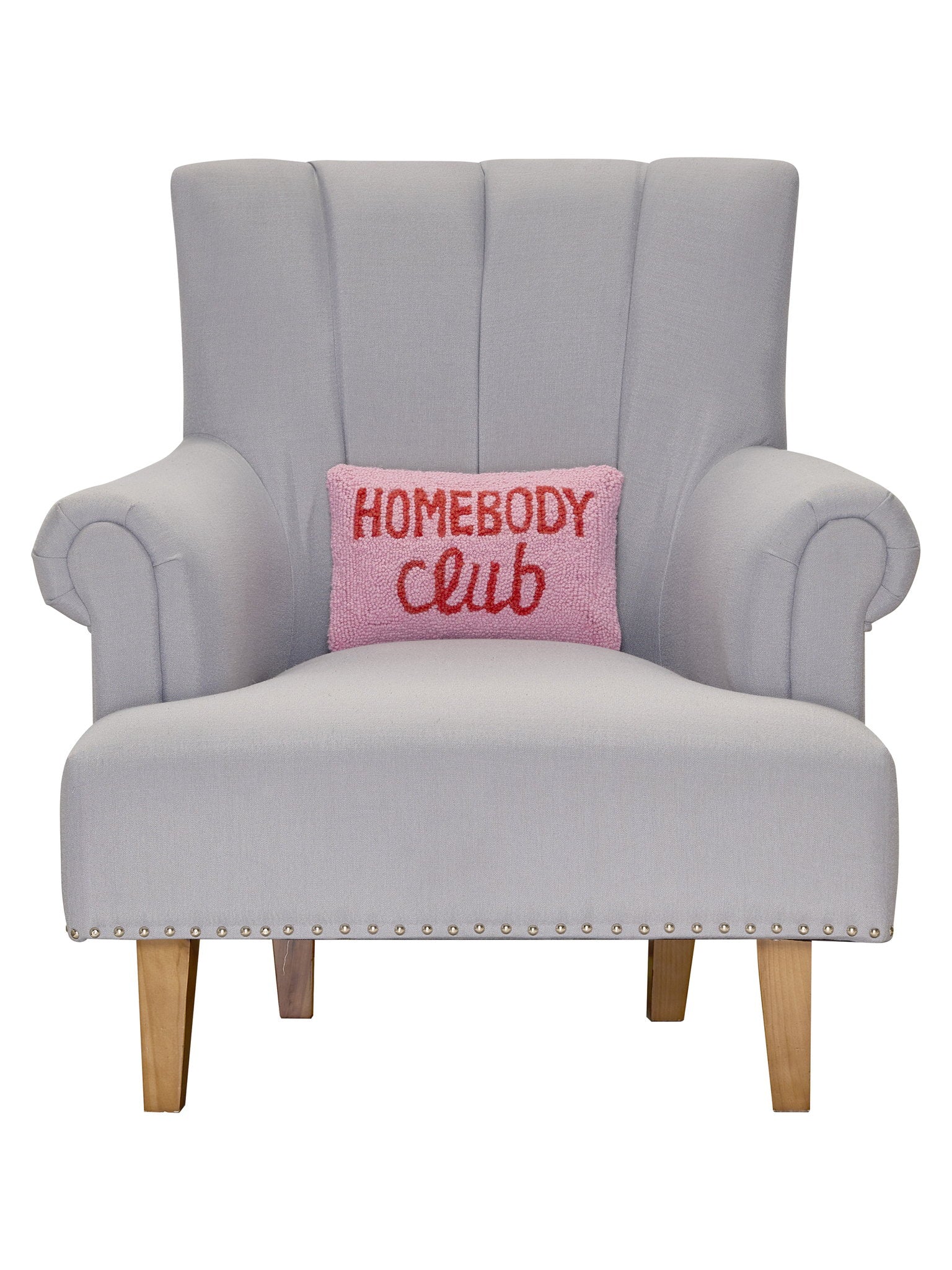Homebody Club Hooked Wool Throw Pillow on an armchair, showing the throw pillow at room scale, 8x12 inch