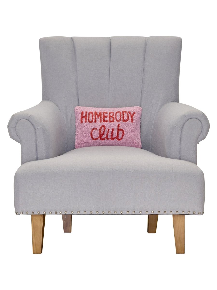 Homebody Club Hooked Wool Throw Pillow on an armchair, showing the throw pillow at room scale, 8x12 inch