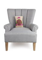 Horseshirt Pink & Green Hooked Wool Throw Pillow on an armchair, showing the throw pillow at room scale, 8x12 inch