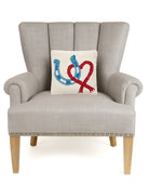 Horseshoe Heart Hooked Wool Throw Pillow on an armchair, showing the throw pillow at room scale, 10x10 inch