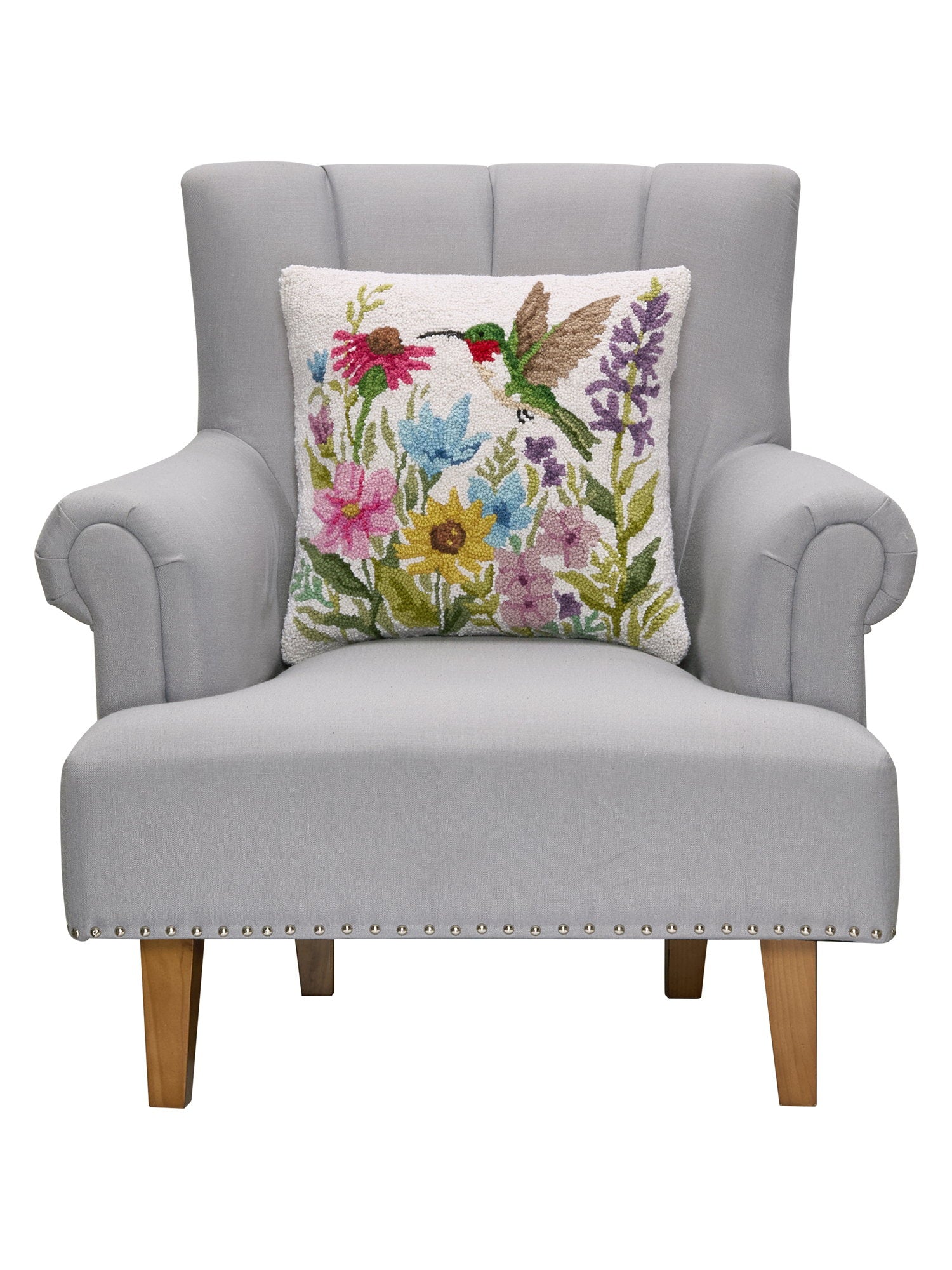 Hummingbird Wildflower Hooked Wool Throw Pillow on an armchair, showing the throw pillow at room scale, 18x18 inch