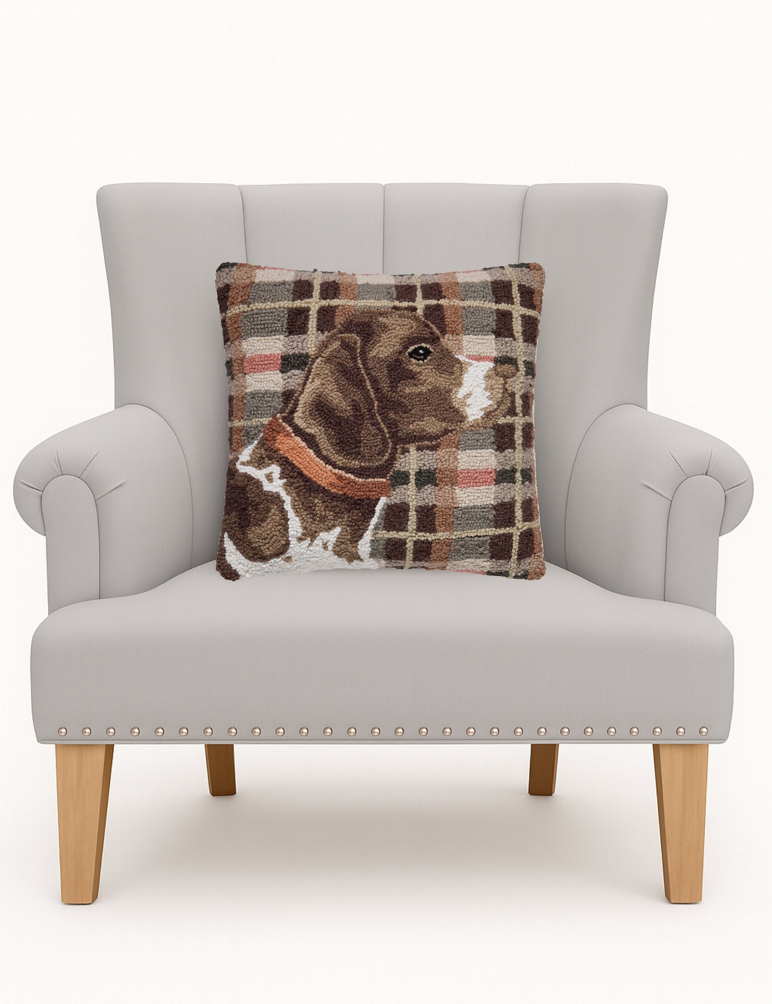 Hunting Dog Hooked Wool Throw Pillow on an armchair, showing the throw pillow at room scale, 16x16 inch