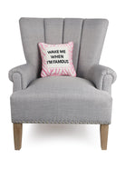 I'm Famous Embroidered Needlepoint Throw Pillow on an armchair, showing the throw pillow at room scale, 12x12 inch