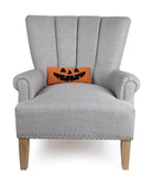 Jack-O-Lantern Hooked Wool Halloween Throw Pillow on an armchair, showing the throw pillow at room scale, 12x5 inch