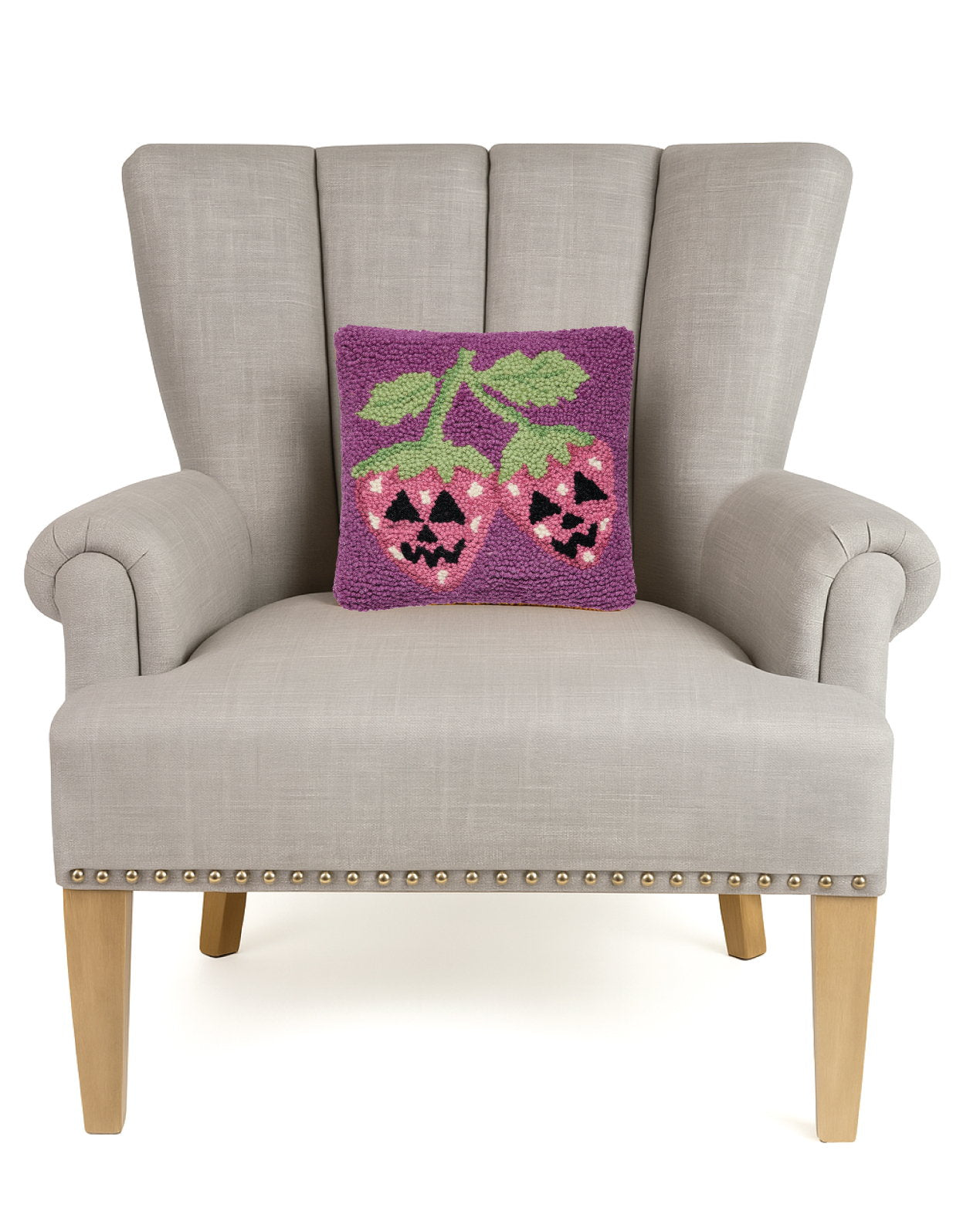 Jack Strawberry Hooked Wool Halloween Throw Pillow on an armchair, showing the throw pillow at room scale, 10x10 inch