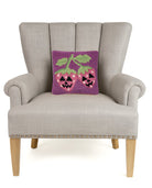 Jack Strawberry Hooked Wool Halloween Throw Pillow on an armchair, showing the throw pillow at room scale, 10x10 inch