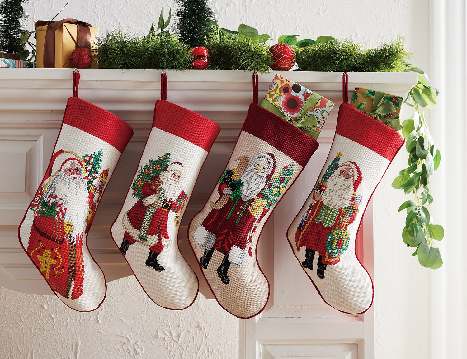 Jingle Claus Embroidered Needlepoint Christmas Stocking shown alongside other designs in the same collection, 11x18 inch