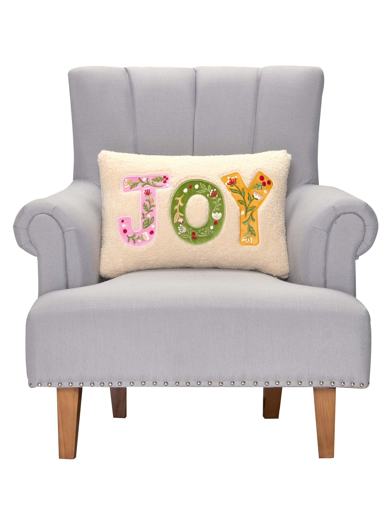 Joy Applique Embroidered Christmas Throw Pillow on an armchair, showing the throw pillow at room scale, 12x18 inch