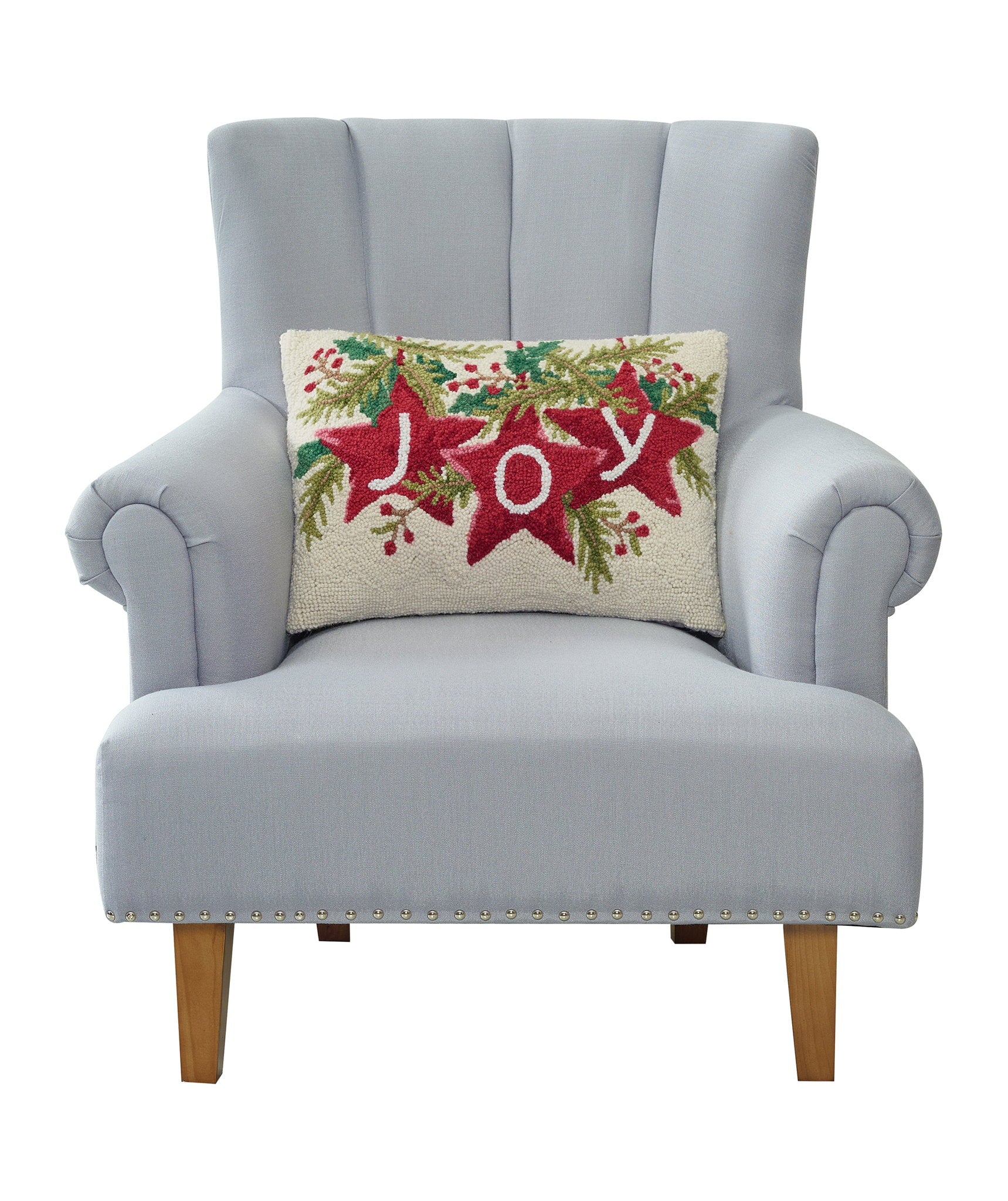 Joy Stars Hooked Wool Christmas Throw Pillow on an armchair, showing the throw pillow at room scale, 14x20 inch