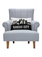 Kansas City Hooked Wool Throw Pillow on an armchair, showing the throw pillow at room scale, 12x20 inch